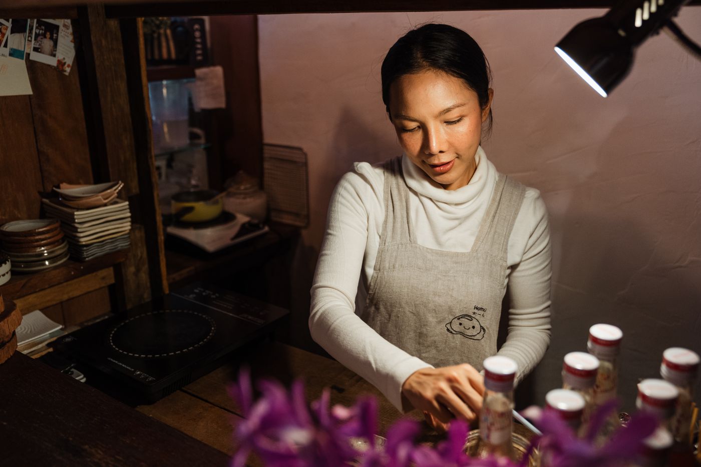 A cafe owner at work behind the counter