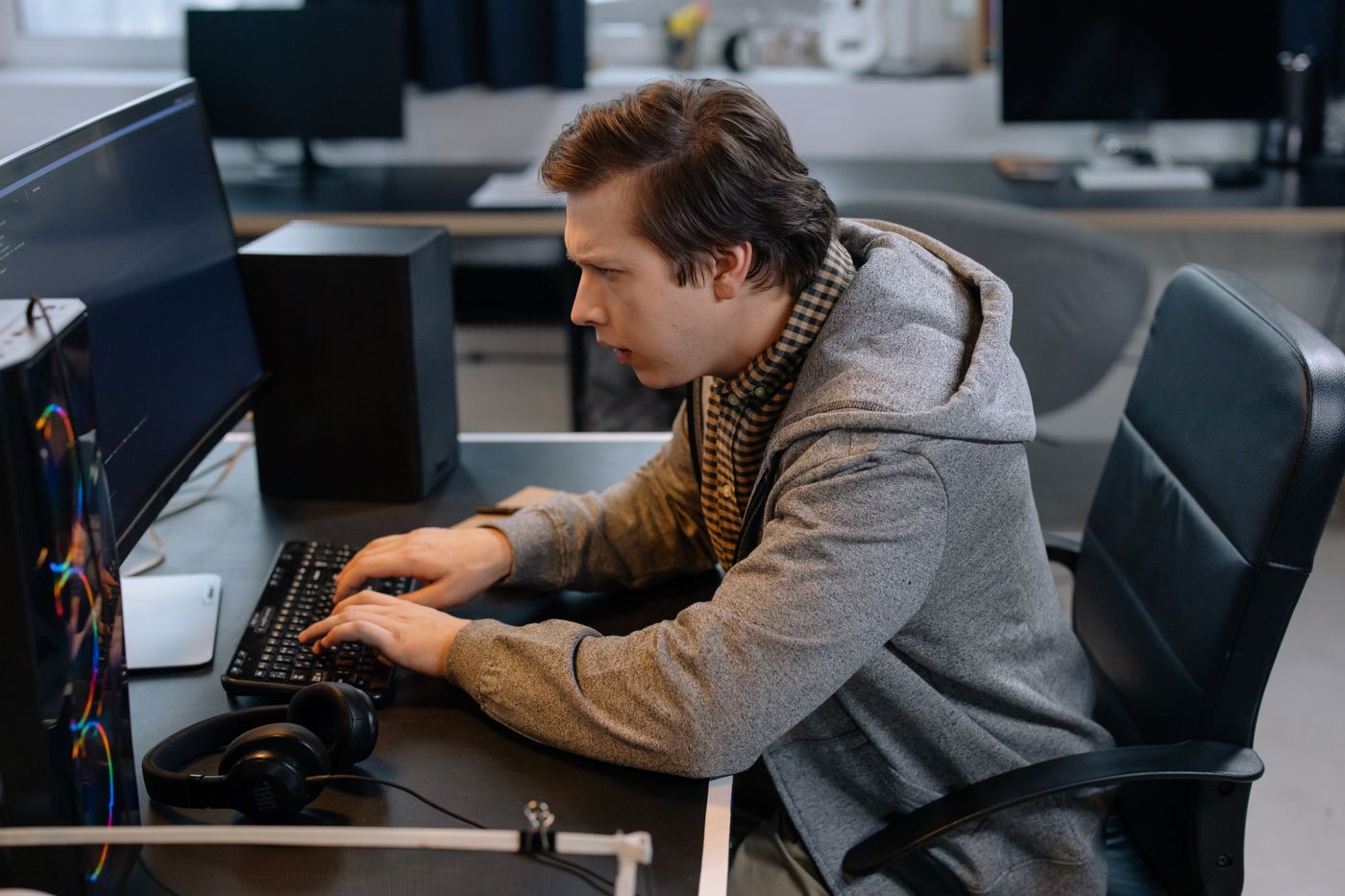 An engineer at work at a desk with a monitor