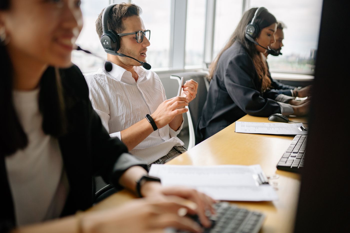 Members of the team on calls at their desks